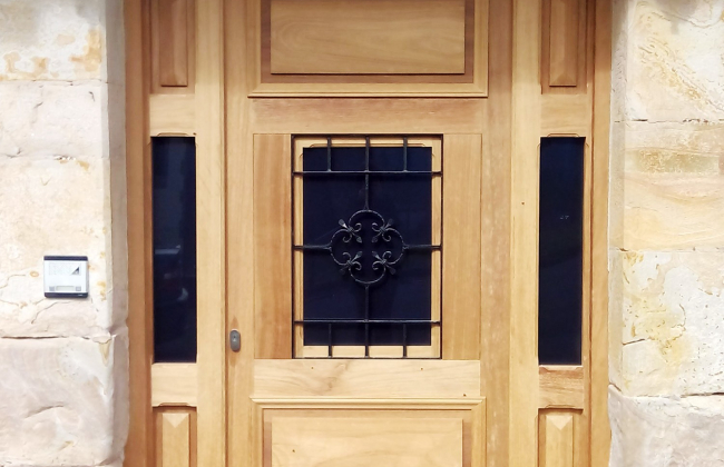 Custom fabrication and installation of wooden outdoor doors.